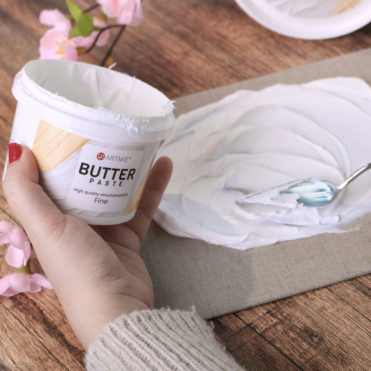 Otvorena kantica i sloj ARTMIE Butter Fine paste nanesen na platno slikarskim nožem